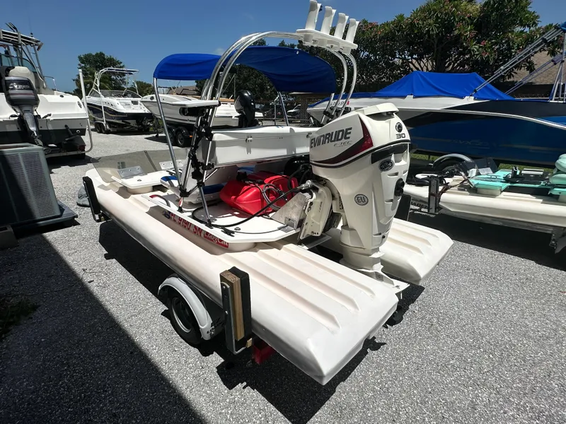 Slide: The Image of 2020 CraigCat E2 Elite with Evinrude motor, parked on a trailer in a boatyard. - 15