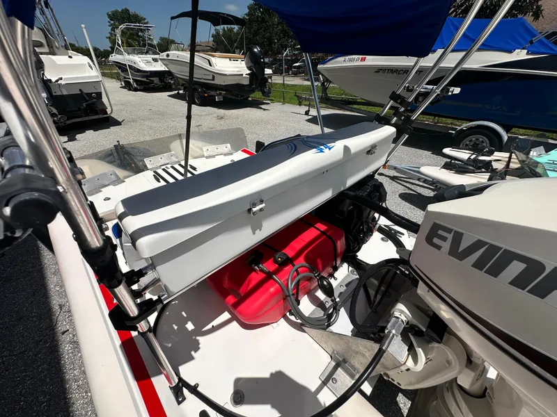 Slide: The Image of 2020 CraigCat E2 Elite with Evinrude motor, parked among other boats. - 20