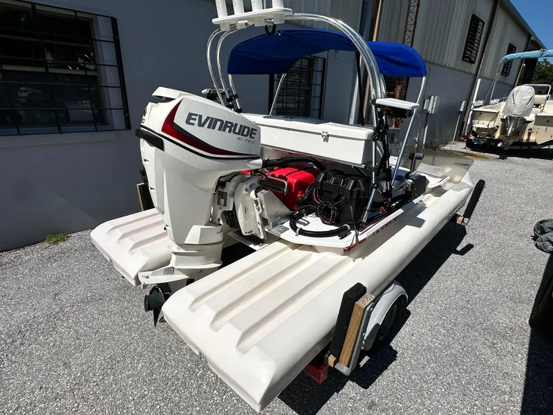 Slide: The Image of 2020 CraigCat E2 Elite with Evinrude motor, parked outdoors on gravel. - 4