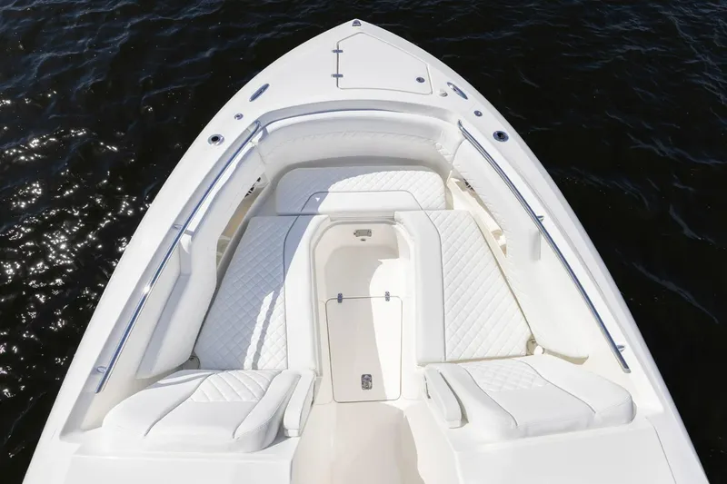 Slide: The Image of 2026 Pursuit DC 306 Dual Console boat with white seating and sleek design on water. - 10