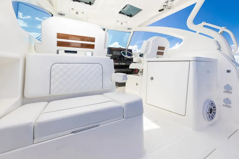 Slide: The Image of 2026 Pursuit DC 306 Dual Console interior with white seating and modern design. - 13