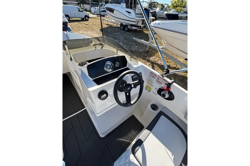 Slide: The Image of 2025 Bayliner Element M17 boat interior with seating and storage compartments. - 10