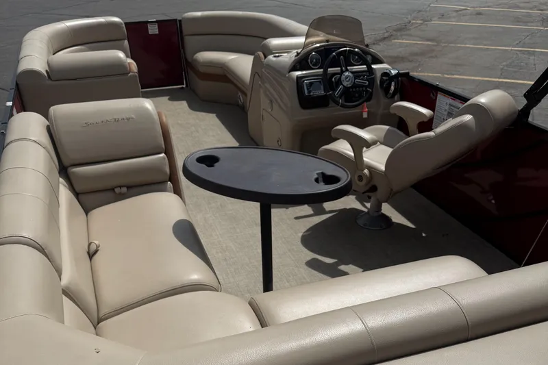 Slide: The Image of 2018 South Bay 523CR pontoon boat interior with beige seating and steering console. - 9