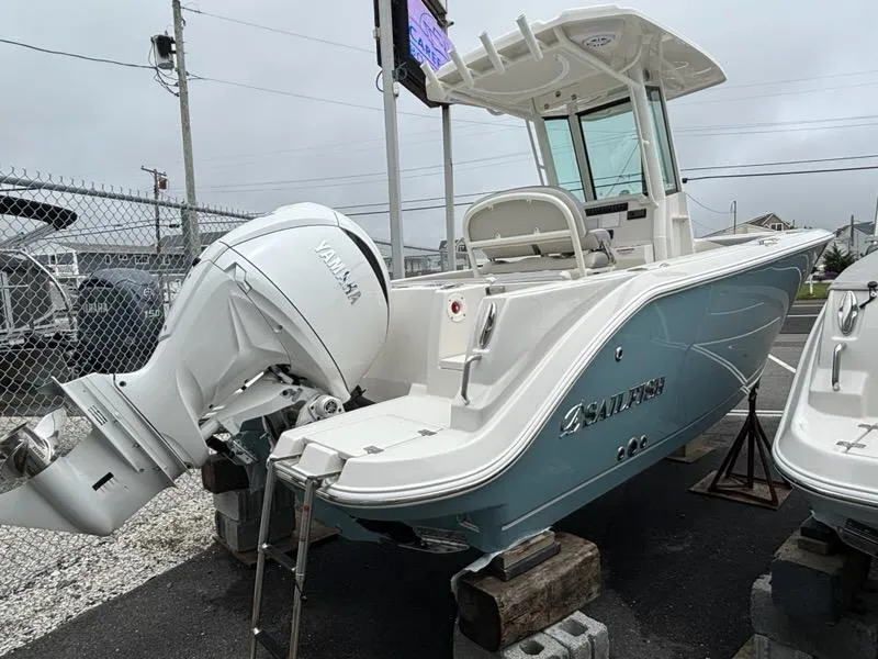 Slide: The Image of 2026 Sailfish 232 CC boat with Yamaha outboard motor, parked on blocks. - 3