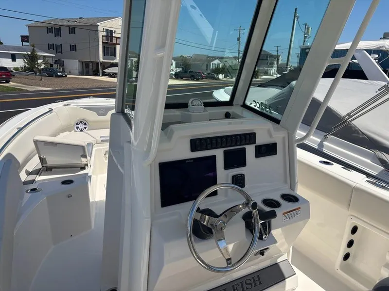 Slide: The Image of 2026 Sailfish 232 CC boat interior with steering wheel and control panel. - 7