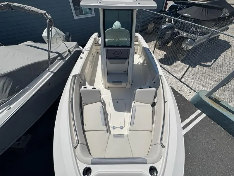 Slide: The Image of 2026 Sailfish 232 CC boat with spacious seating and modern design in a marina setting. - 8