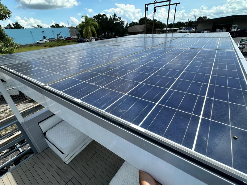 Slide: The Image of Rooftop solar panels on Modern Struktures AGF Cruise, 2023 model, under a sunny sky. - 15