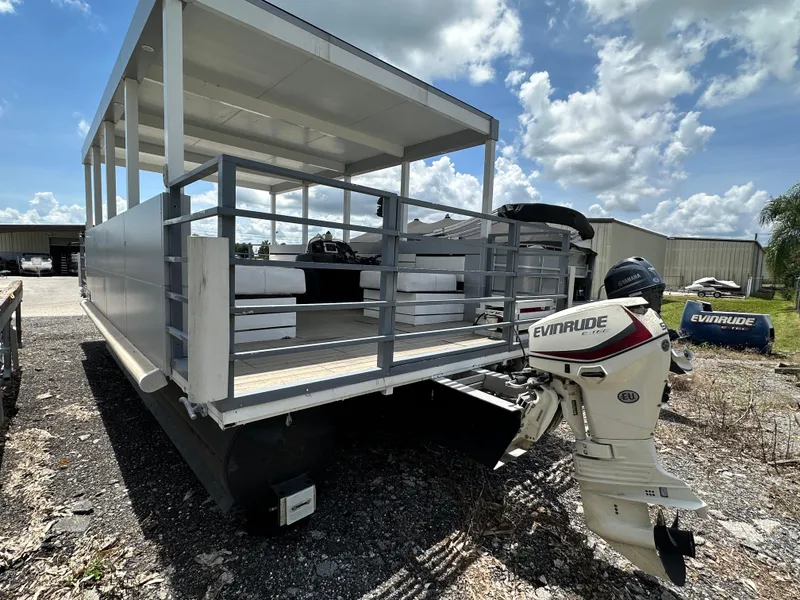 Slide: The Image of Modern Struktures AGF Cruise 2023 pontoon boat with Evinrude outboard motor, parked outdoors. - 4