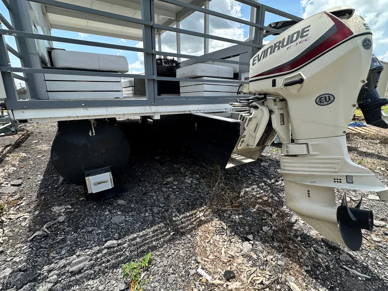 Slide: The Image of Modern Struktures AGF Cruise 2023 pontoon boat with Evinrude outboard motor on rocky terrain. - 5