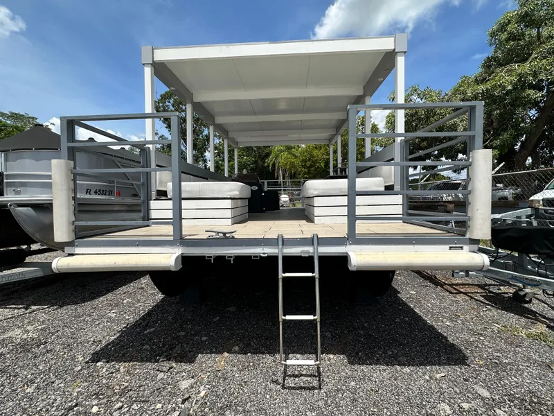 Slide: The Image of Modern Struktures 2023 AGF Cruise pontoon boat with canopy and seating, parked outdoors. - 6