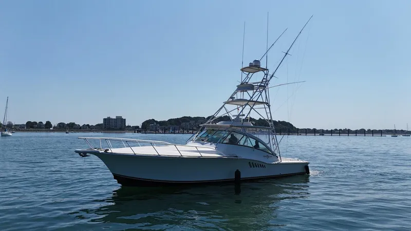 Slide: The Image of 2007 Albemarle 410 Express Fisherman yacht on calm water, clear sky background. - 12
