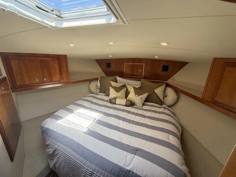 Slide: The Image of Luxurious cabin interior of 2007 Albemarle 410 Express Fisherman with cozy bedding and wood accents. - 25