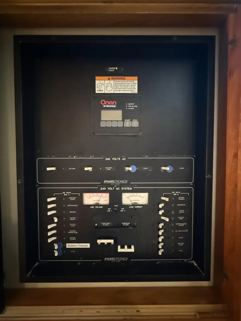 Slide: The Image of Electrical panel of a 2007 Albemarle 410 Express Fisherman boat, featuring Onan generator controls. - 26