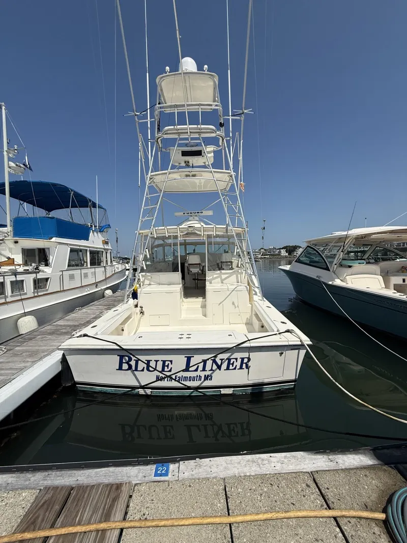 Slide: The Image of 2007 Albemarle 410 Express Fisherman docked, rear view, with "Blue Liner" name visible. - 3