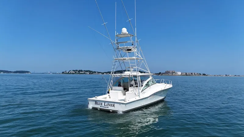 Slide: The Image of 2007 Albemarle 410 Express Fisherman boat on calm waters under clear blue sky. - 4
