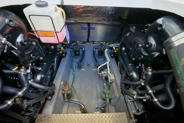 Slide: The Image of Engine room of a 2015 Carver C34 Command Bridge, showcasing mechanical components and systems. - 25