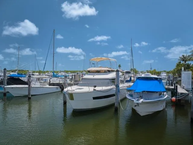 Slide: The Image of 2015 Carver C34 Command Bridge yacht docked in a sunny marina. - 28