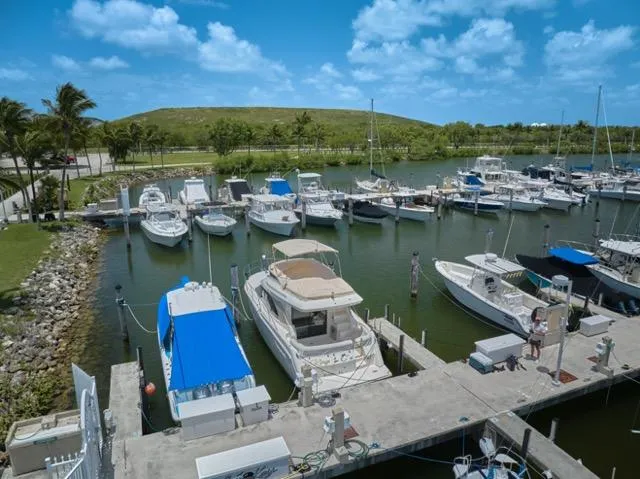 Slide: The Image of Marina with boats, featuring a 2015 Carver C34 Command Bridge under a clear blue sky. - 31