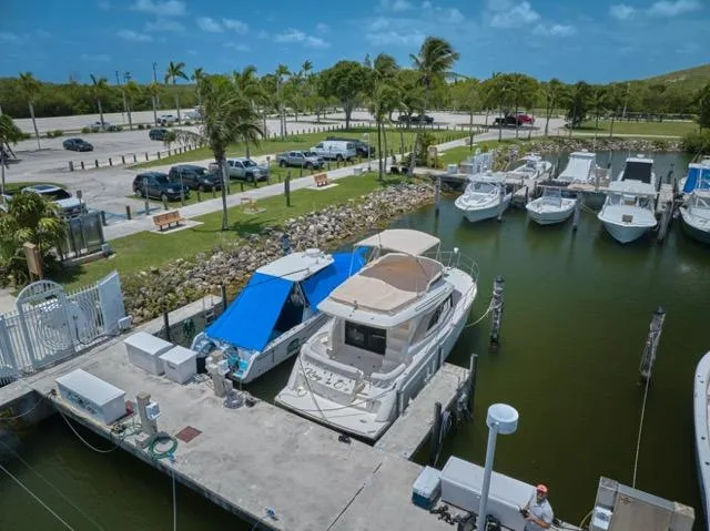 Slide: The Image of 2015 Carver C34 Command Bridge docked at a marina under a clear blue sky. - 32