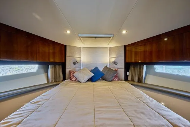 Slide: The Image of Luxurious bedroom interior of 2015 Carver C34 Command Bridge yacht with elegant bedding and wood accents. - 6