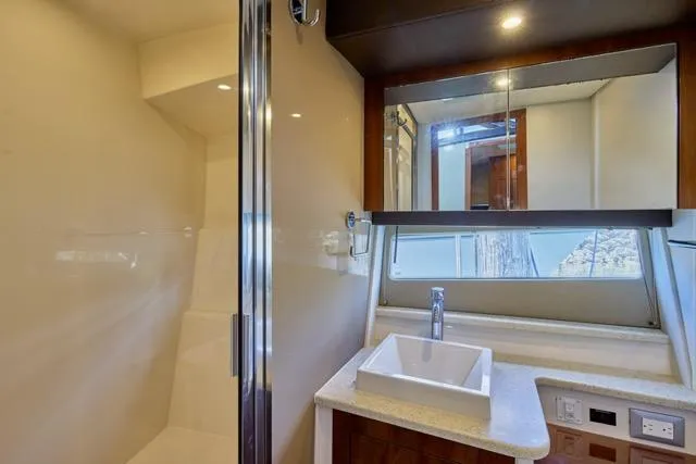 Slide: The Image of Modern bathroom in 2015 Carver C34 Command Bridge yacht with sleek fixtures and mirror. - 8
