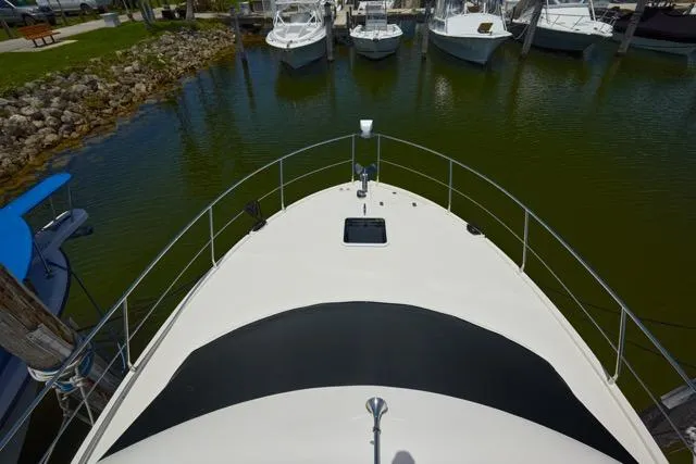 Slide: The Image of Bow view of 2015 Carver C34 Command Bridge docked in a marina. - 19