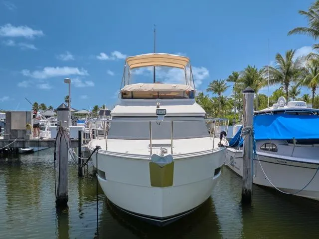 Slide: The Image of 2015 Carver C34 Command Bridge yacht docked at marina under clear blue sky. - 27