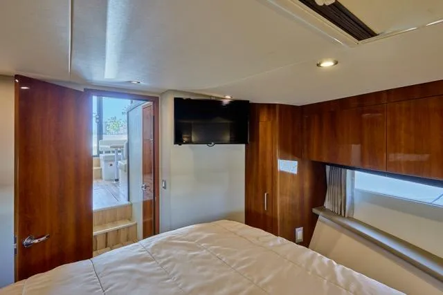 Slide: The Image of Luxurious cabin interior of 2015 Carver C34 Command Bridge yacht with wood paneling and TV. - 7
