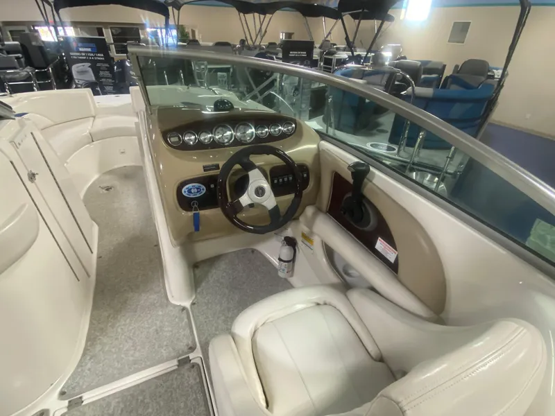 Slide: The Image of 2002 Chaparral Sunesta 243 boat interior with steering wheel and dashboard controls. - 4