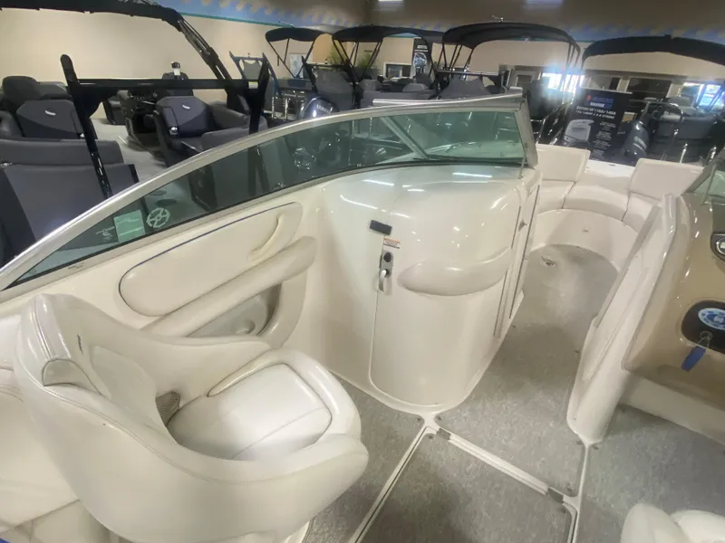 Slide: The Image of 2002 Chaparral Sunesta 243 boat interior with white seating and sleek design. - 5