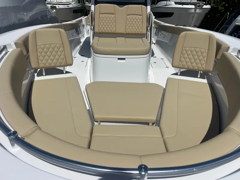 Slide: The Image of 2026 Sportsman 321 Heritage boat interior with beige cushioned seating and modern design. - 14