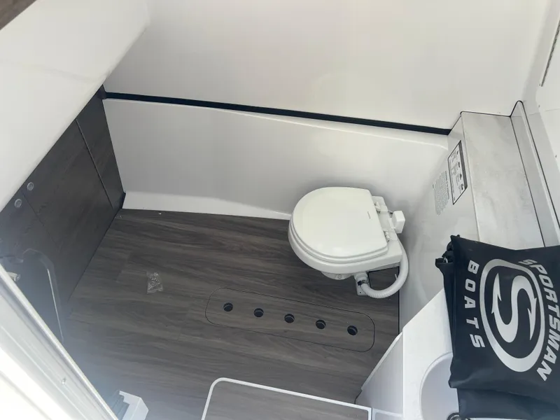 Slide: The Image of 2026 Sportsman 321 Heritage boat interior with modern toilet and sleek design. - 15
