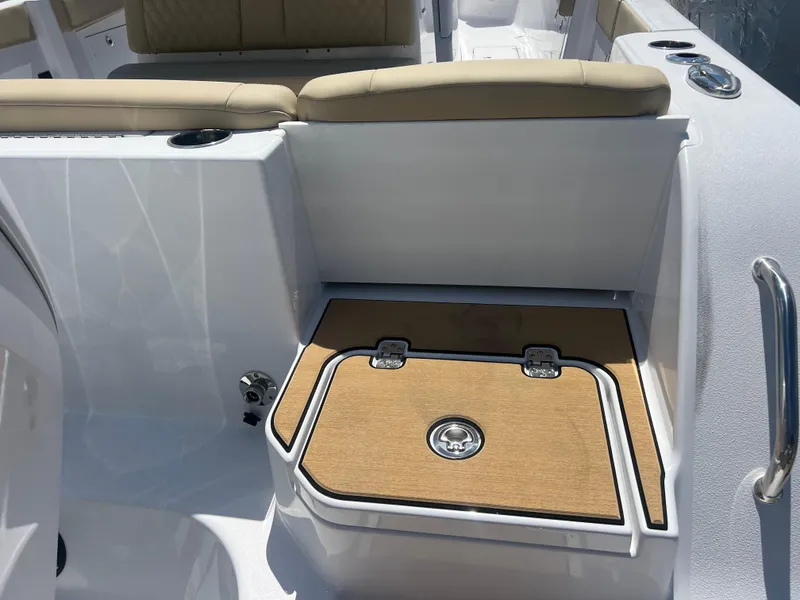Slide: The Image of 2026 Sportsman 321 Heritage boat interior with cushioned seating and storage compartment. - 17