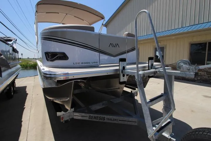 Slide: The Image of 2025 Avalon LSZ Versatile Rear Bench pontoon boat on Genesis trailer. - 1