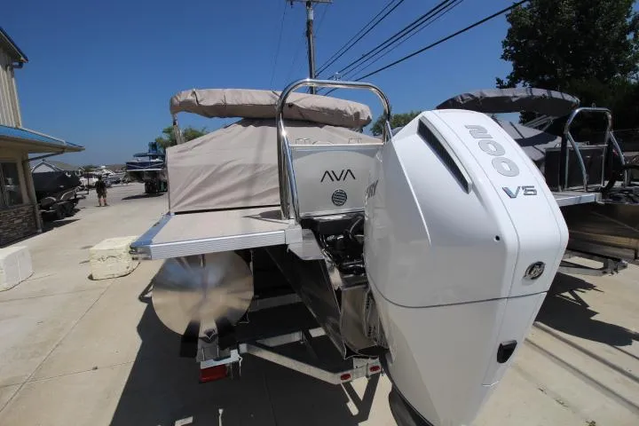 Slide: The Image of 2025 Avalon LSZ Versatile Rear Bench boat with powerful 200 V6 engine, docked outdoors. - 3