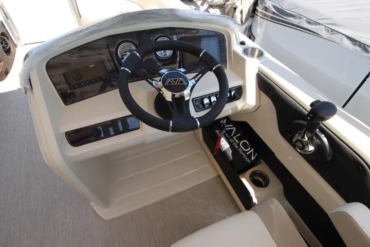 Slide: The Image of 2025 Avalon LSZ Versatile Rear Bench boat dashboard with steering wheel and controls. - 8