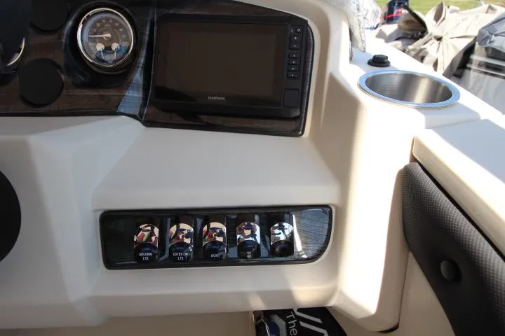 Slide: The Image of Control panel of 2025 Avalon LSZ Versatile Rear Bench boat with switches and display. - 9