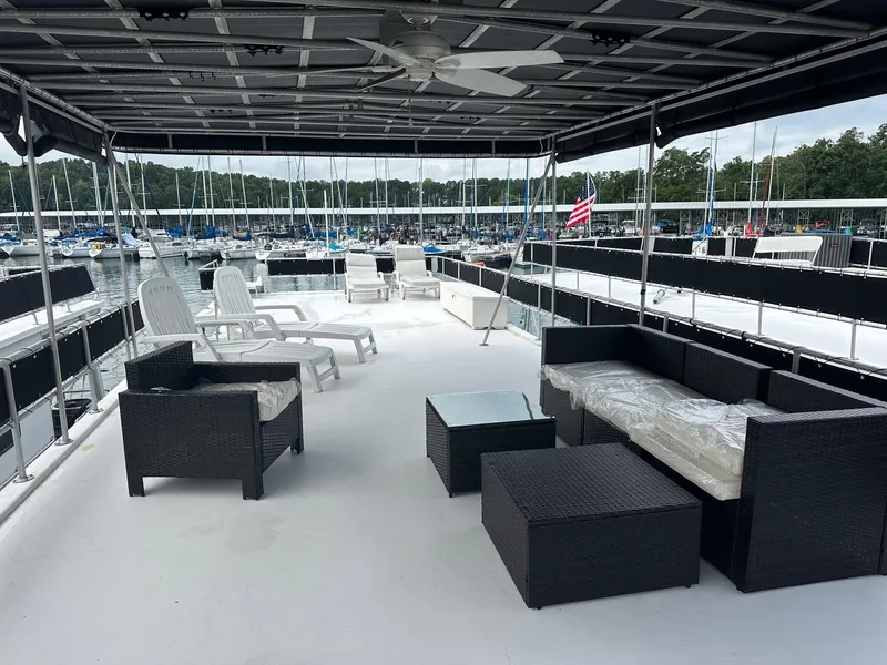 Slide: The Image of Spacious deck of 1992 Sumerset 14x66 houseboat with outdoor seating and marina view. - 13