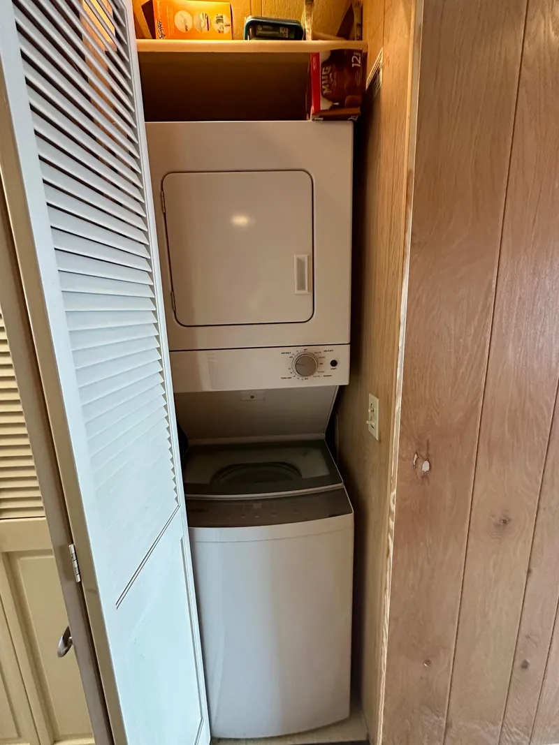 Slide: The Image of Stacked washer and dryer in a compact wooden closet, Sumerset 14x66, 1992 model. - 14