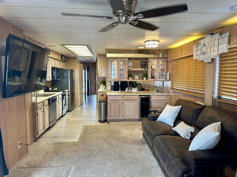 Slide: The Image of Interior of a 1992 Sumerset 14x66 houseboat with modern kitchen and cozy living area. - 2