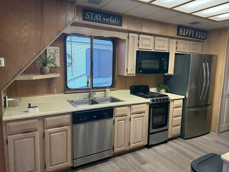 Slide: The Image of Kitchen in a 1992 Sumerset 14x66 houseboat with modern appliances and wood cabinetry. - 4