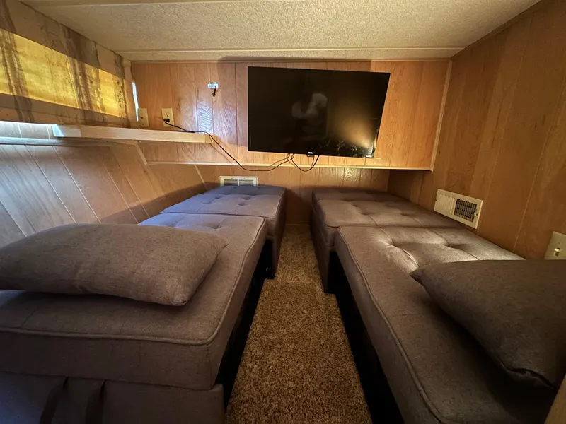 Slide: The Image of Interior of 1992 Sumerset 14x66 houseboat with twin beds and wall-mounted TV. - 8