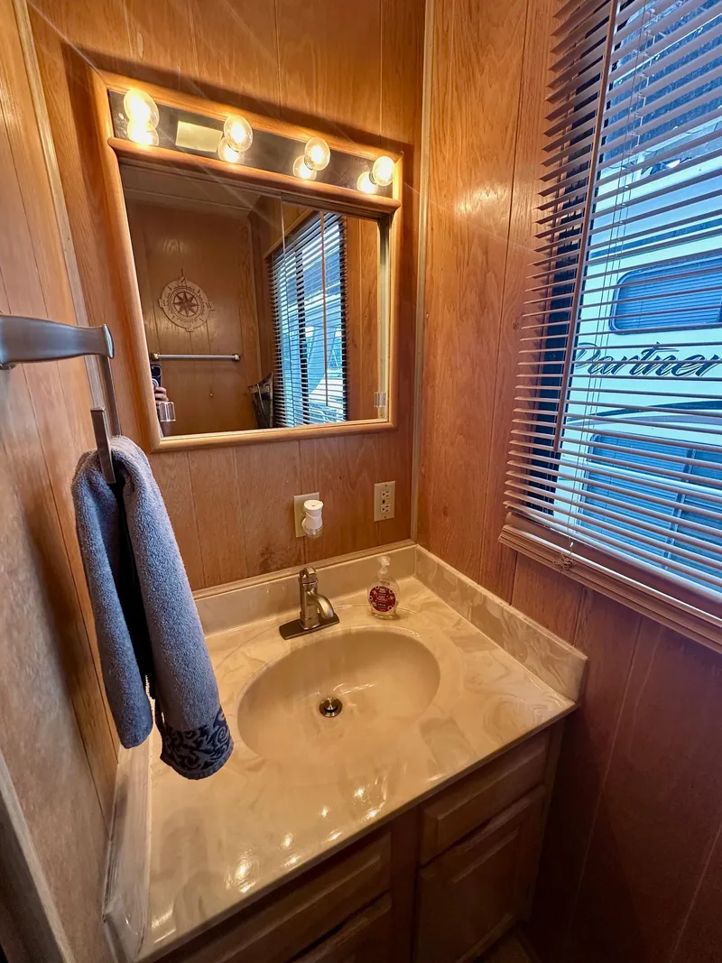 Slide: The Image of Bathroom vanity in 1992 Sumerset 14x66 houseboat with mirror and lighting. - 9