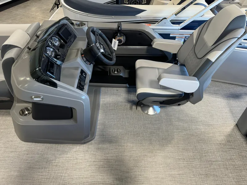 Slide: The Image of Captain's chair and helm of 2025 Avalon LSZ VRB pontoon boat, featuring modern controls. - 5