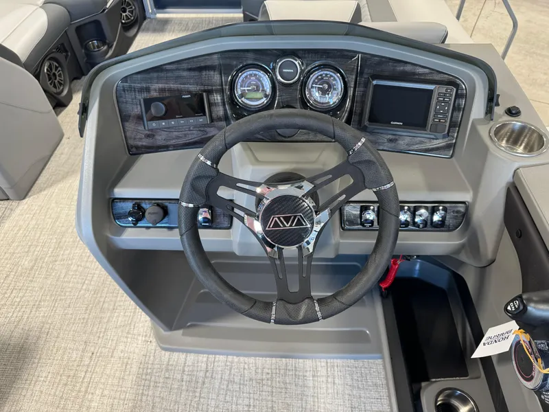 Slide: The Image of 2025 Avalon LSZ VRB boat dashboard with steering wheel, gauges, and control panel. - 6