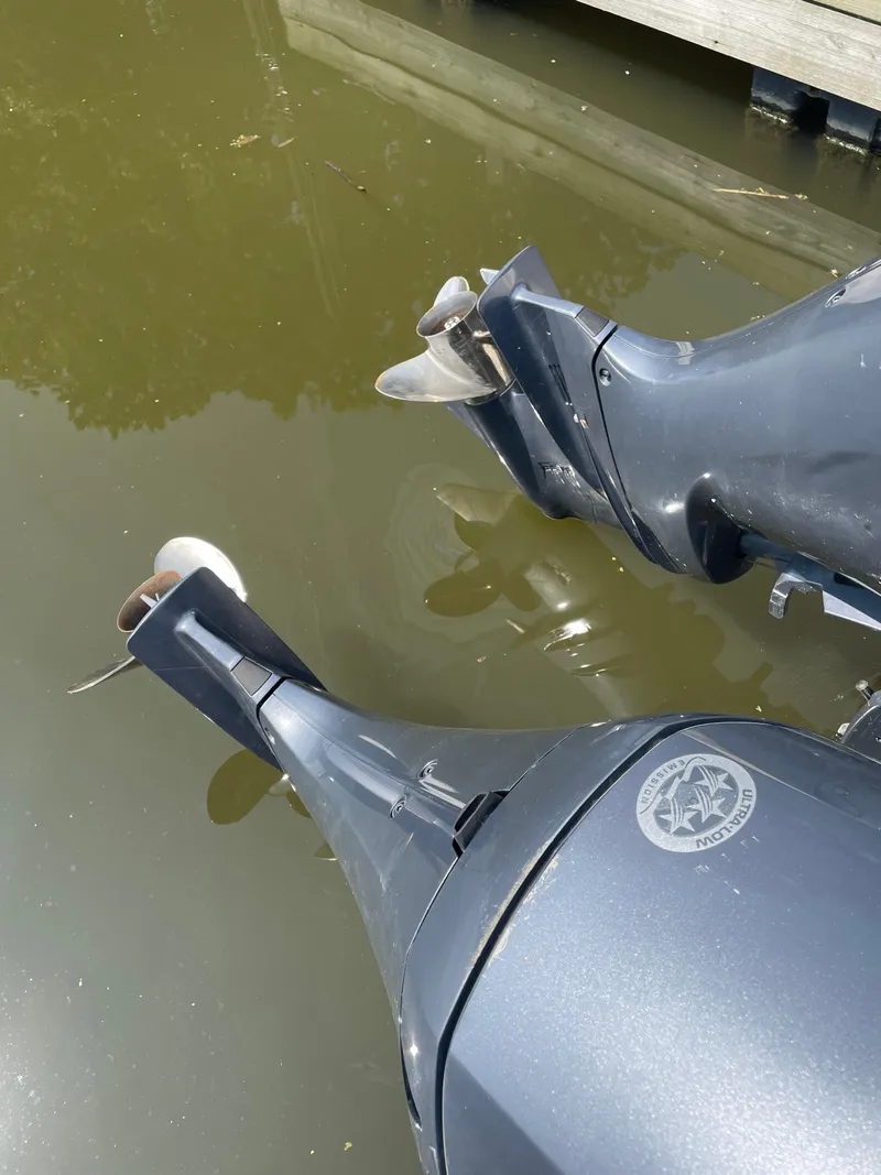 Slide: The Image of Outboard motors of a 2023 Sailfish 276 DC boat in water. - 8