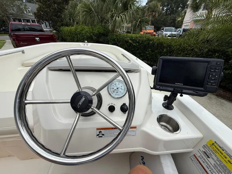Slide: The Image of 2022 Boston Whaler 160 Super Sport dashboard with steering wheel and Garmin display. - 10