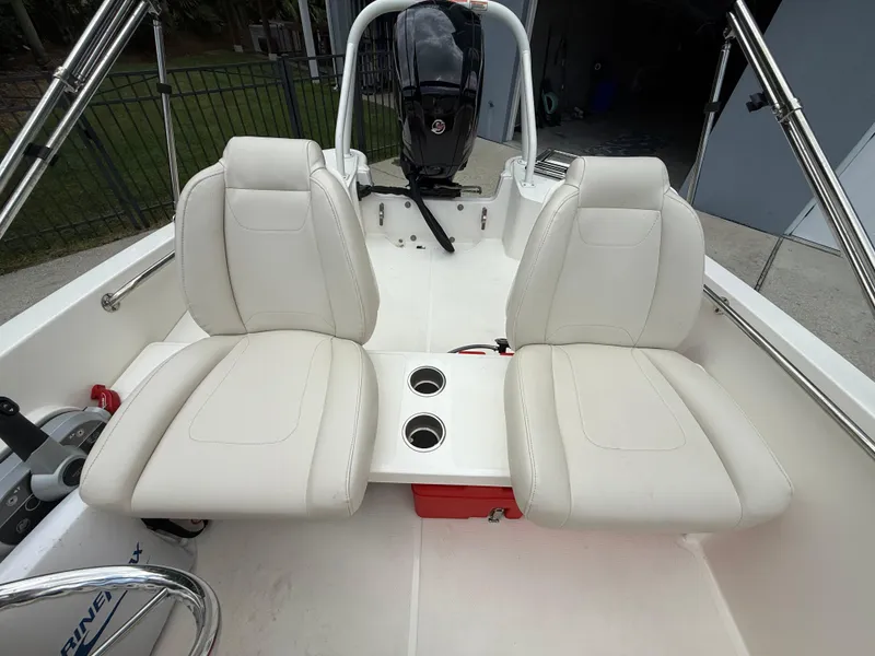 Slide: The Image of 2022 Boston Whaler 160 Super Sport interior with white seats and dual cup holders. - 12