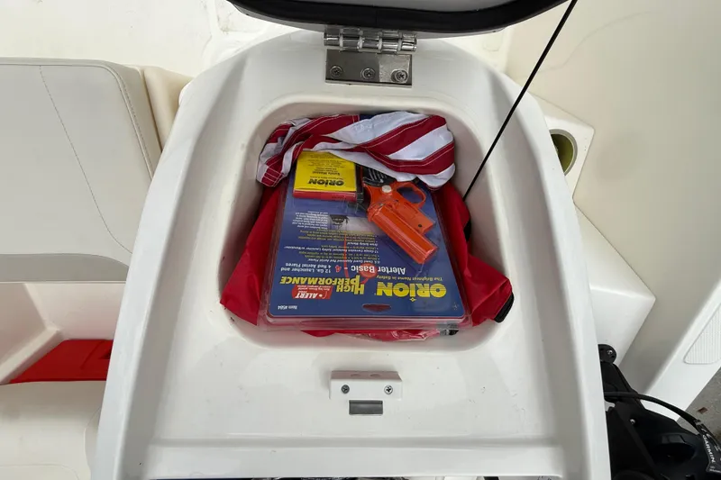 Slide: The Image of Storage compartment of 2022 Boston Whaler 160 Super Sport with safety equipment. - 17