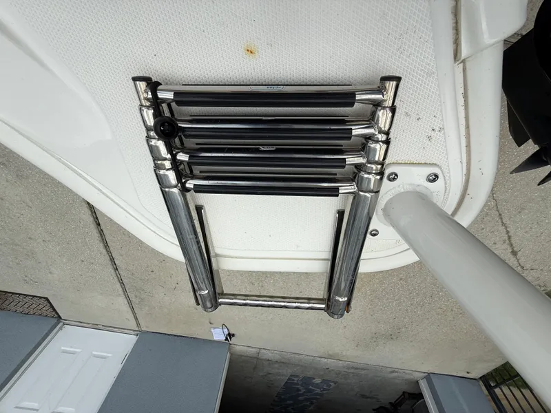 Slide: The Image of 2022 Boston Whaler 160 Super Sport boat ladder, folded on deck. - 18